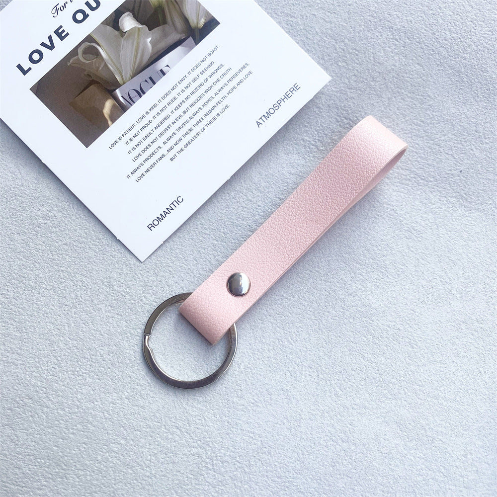 Pink leather keychain, modern and durable key organizer.