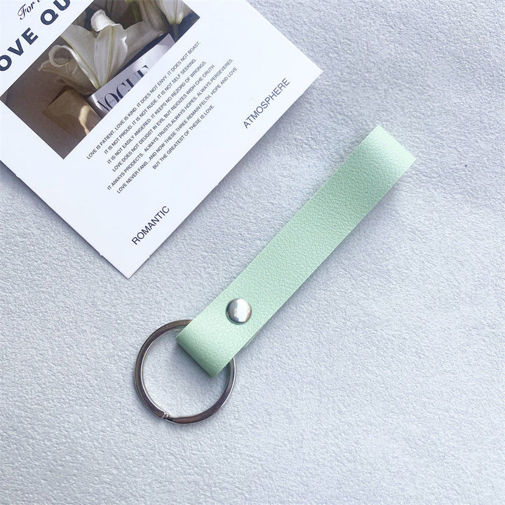 Orange leather key fob, vibrant & high-quality unisex accessory.