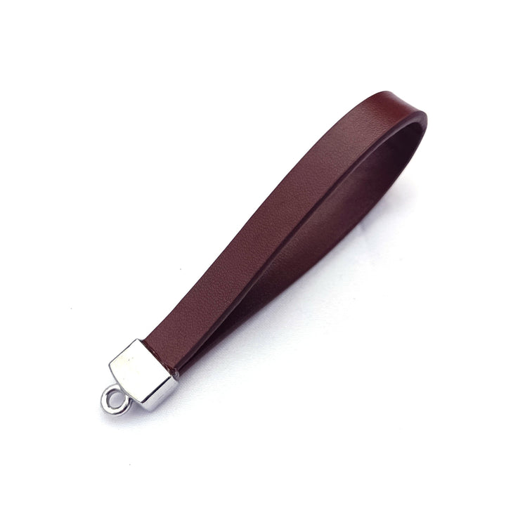 Compact tan leather key chain, perfect for keeping car keys organized and accessible. A durable accessory.