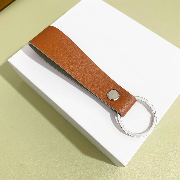 Minimalist leather key fob cover, ensures durability and protection.