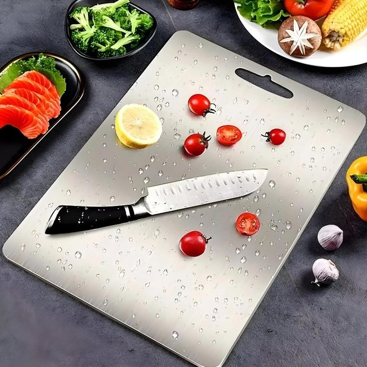 Thick, professional silver stainless steel cutting board, ideal for hygienic kitchen food prep.