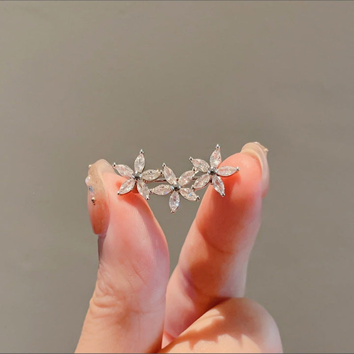 Radiant gemstone flower brooch for women, sparkling elegant accessory.