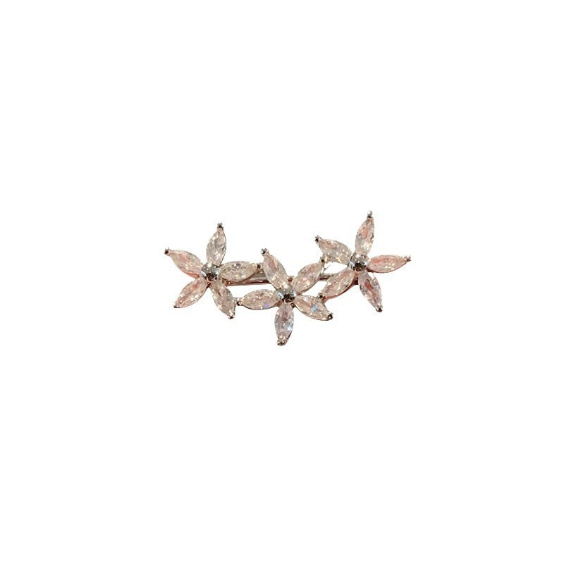 Intricate flower design brooch featuring radiant multi-colored gemstones, stylish women's jewelry.