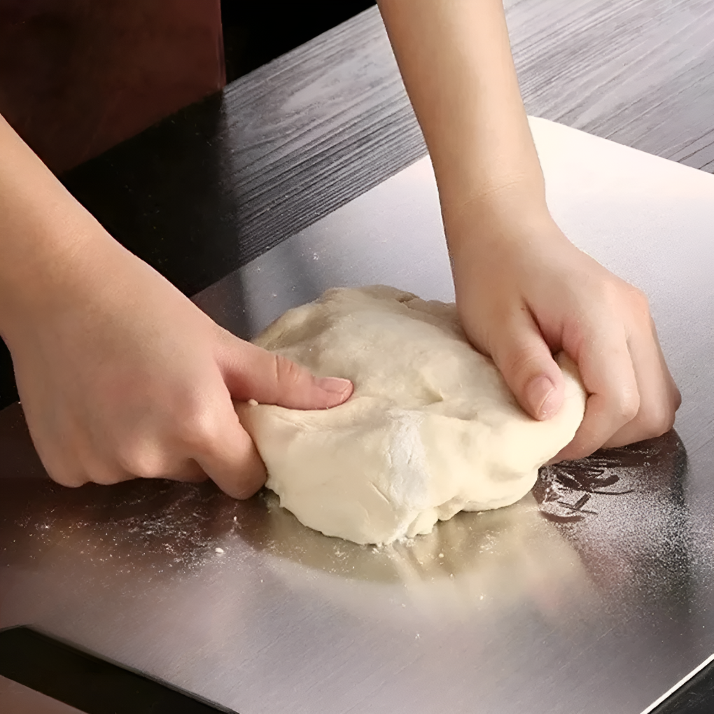 Professional kitchen titanium cutting board, ultra-durable and hygienic for safe food preparation. Stainless steel finish.