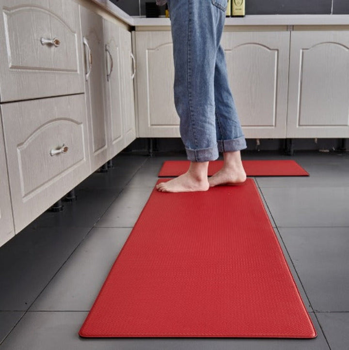 Durable black anti-fatigue floor mat, non-slip & water-resistant, enhances safety & comfort in any kitchen.