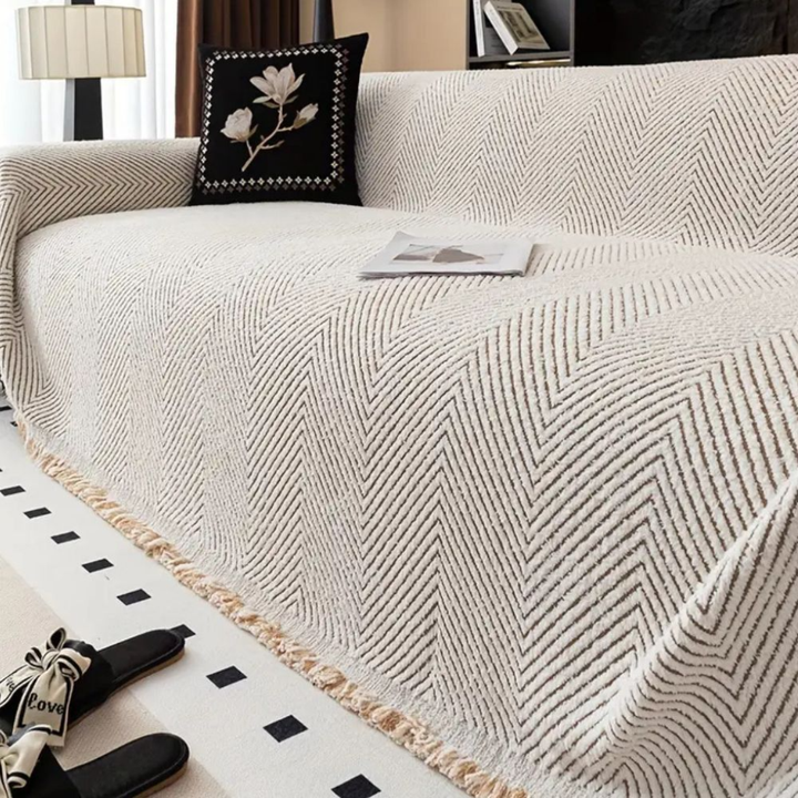 Woven textile sofa throw, reversible herringbone design. Durable slipcover for stylish home decor & protection.
