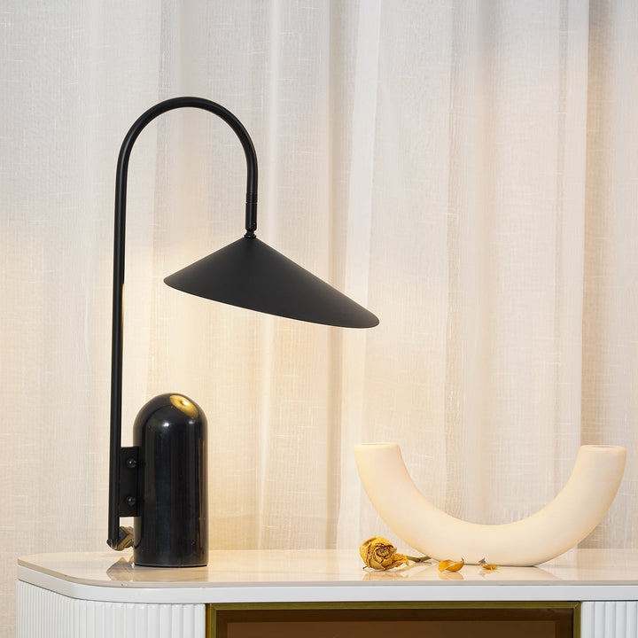 Compact Reyaris table lamp, arch design, modern solution for small spaces.