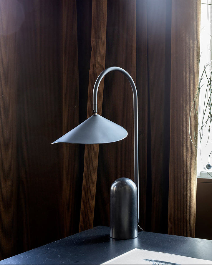 Contemporary Reyaris arch table lamp, clean lines, elegant lighting.