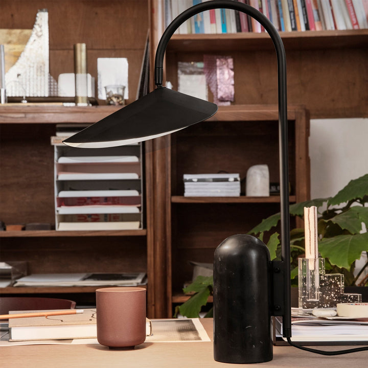 Stylish Reyaris table lamp, arch design, complements modern decor trends.