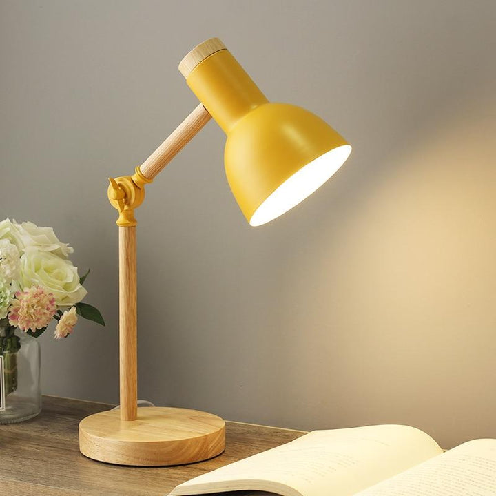 Natural wood table lamp in a Scandinavian style. A modern foldable desk lamp for contemporary home decor.