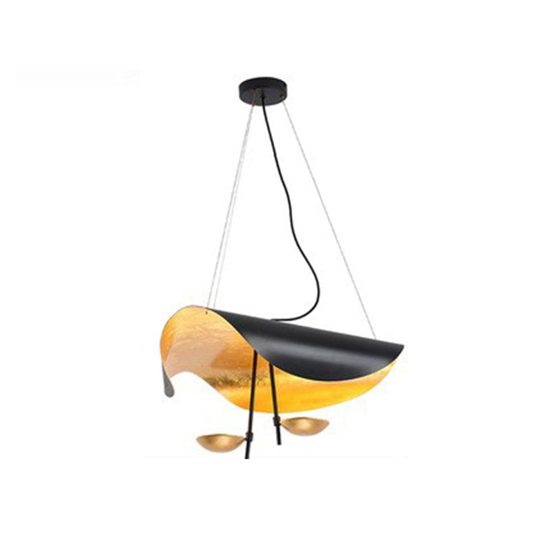 Modern leaf design pendant light, gold, illuminating a stylish contemporary kitchen island.