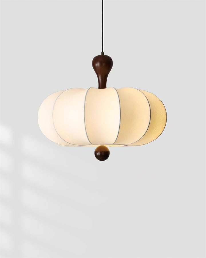 Warm glow from sculptural walnut & white fabric pendant light. Dimmable modern ceiling fixture.