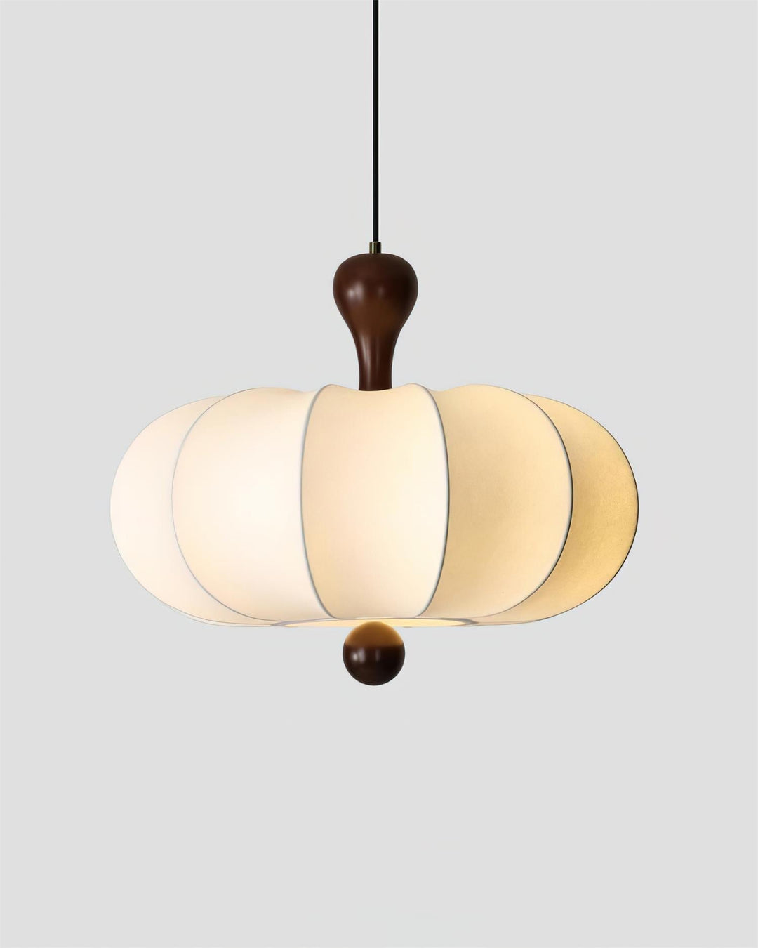 Sculptural walnut & white fabric pendant light installed. Modern ceiling lighting for a dining area.