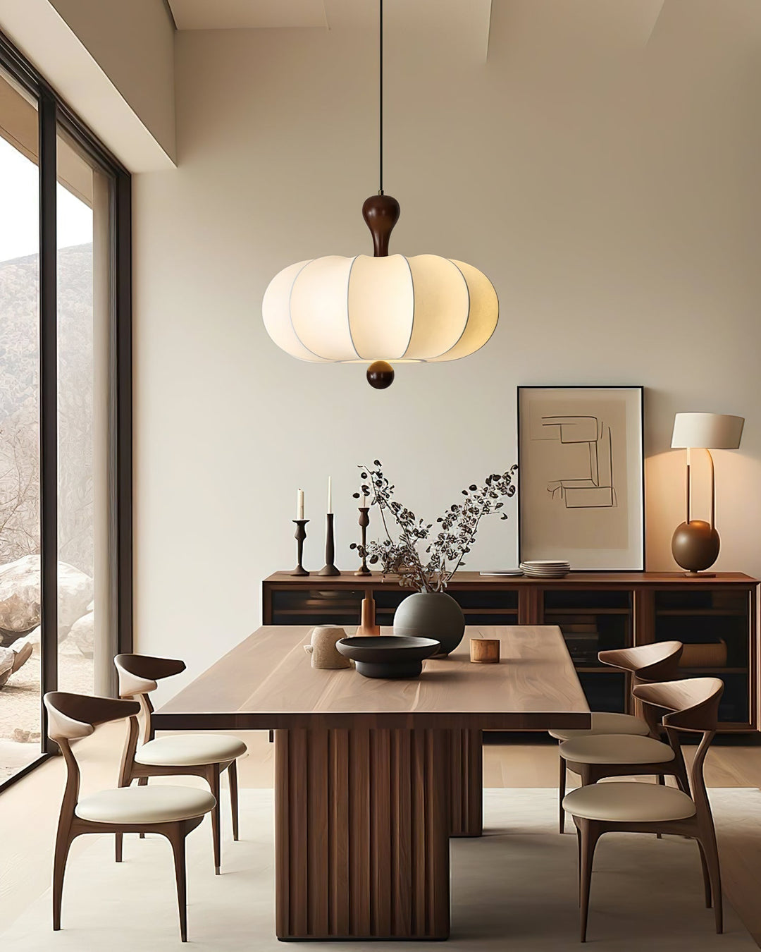 Textured white fabric shade of a sculptural walnut pendant light. Modern ceiling decor.