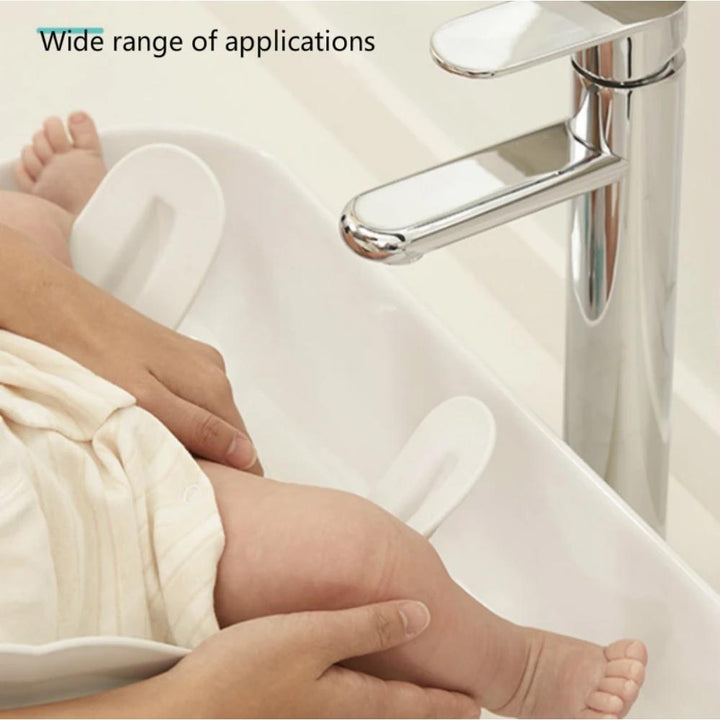 Easy wash, secure baby bath seat in green & white for infant & toddler hygiene. A safe bathing newborn essential.