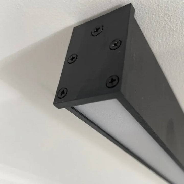 Minimalist black linear LED flush mount ceiling fixture for sleek, contemporary interior lighting.