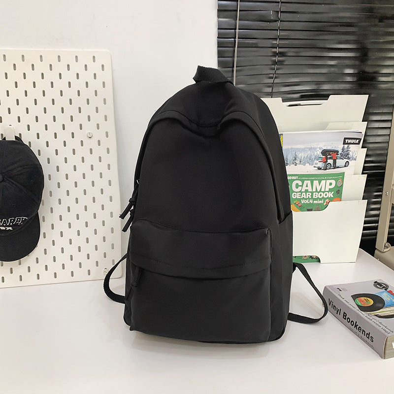 Sleek black minimalist unisex daily commute backpack. Durable, water-resistant design for work, travel, and student use.