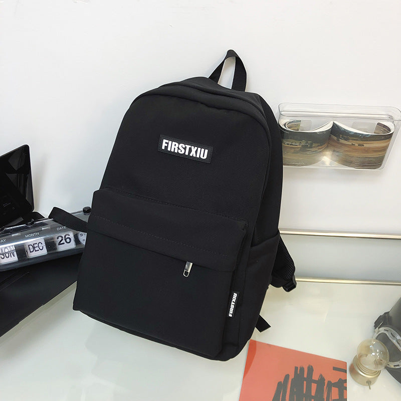 Sleek black minimalist unisex everyday backpack, perfect for urban commuting and modern style. Features clean lines.