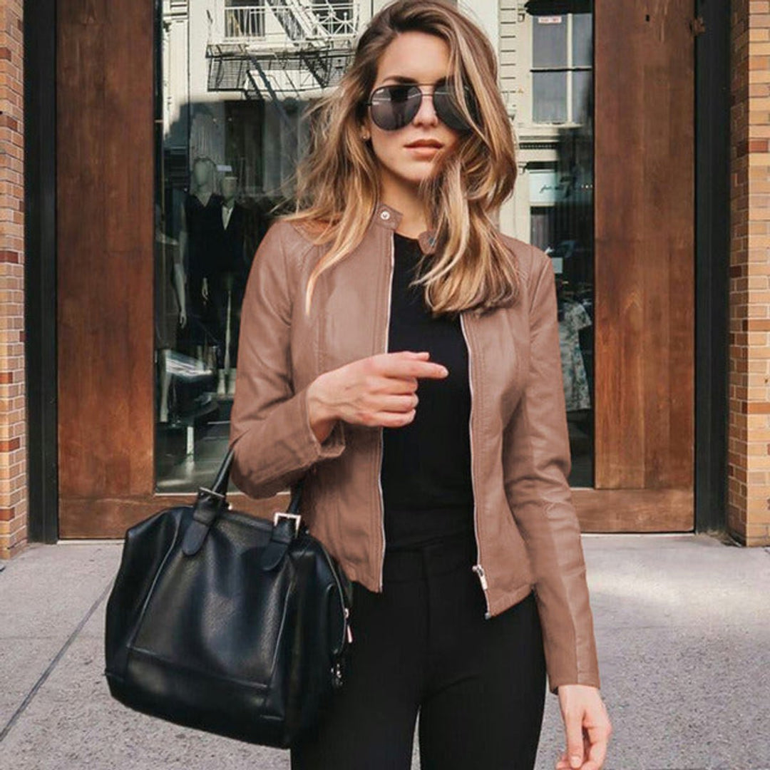 Rose gold hardware on a sleek women's slim fit zip-up jacket for an elegant, modern look.
