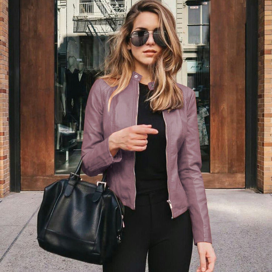 Flattering women's slim fit jacket with a smooth zip-up front, embodying modern city fashion.