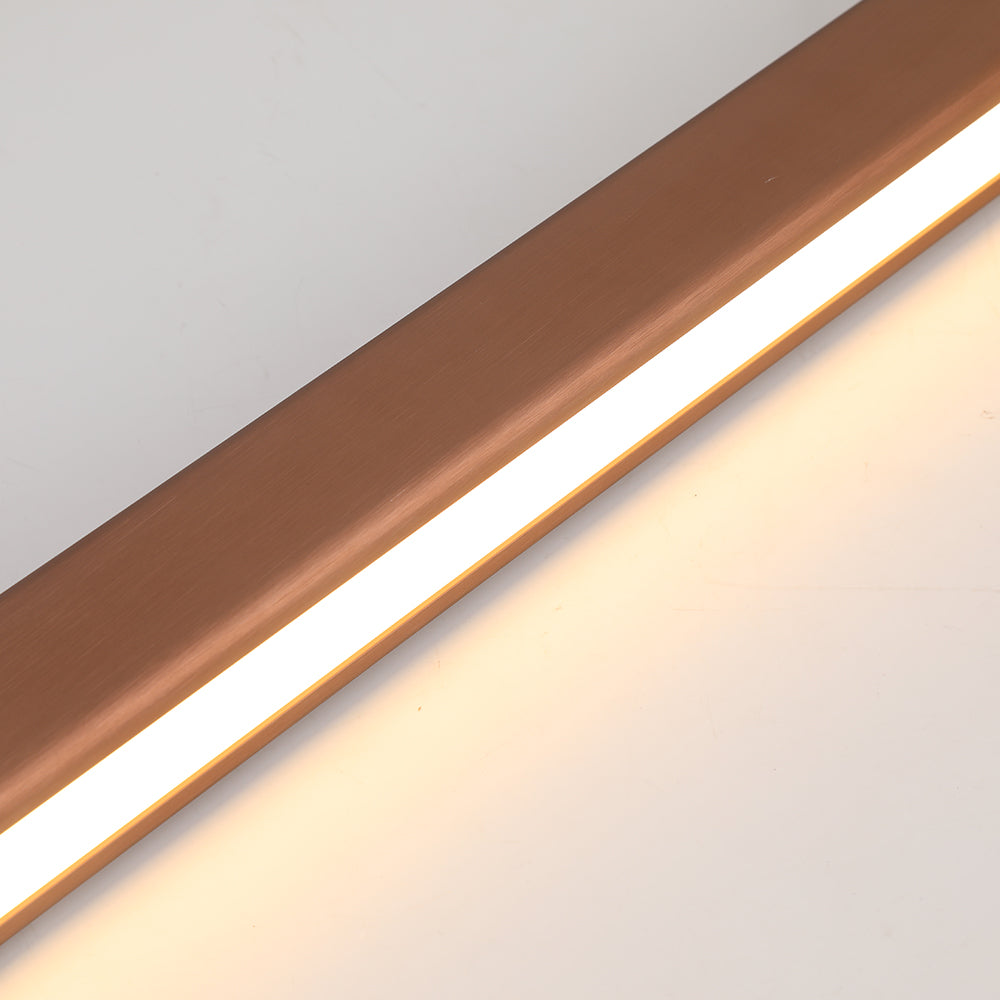 Linear pendant light illuminating a modern dining area with warmth.