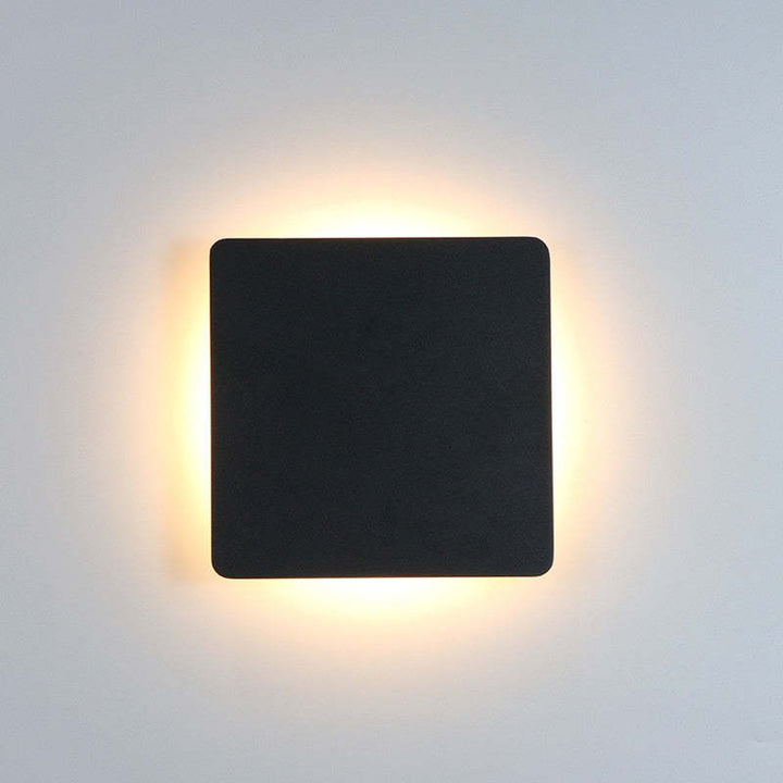Sleek black outdoor LED wall light, perfect for contemporary garden decor.
