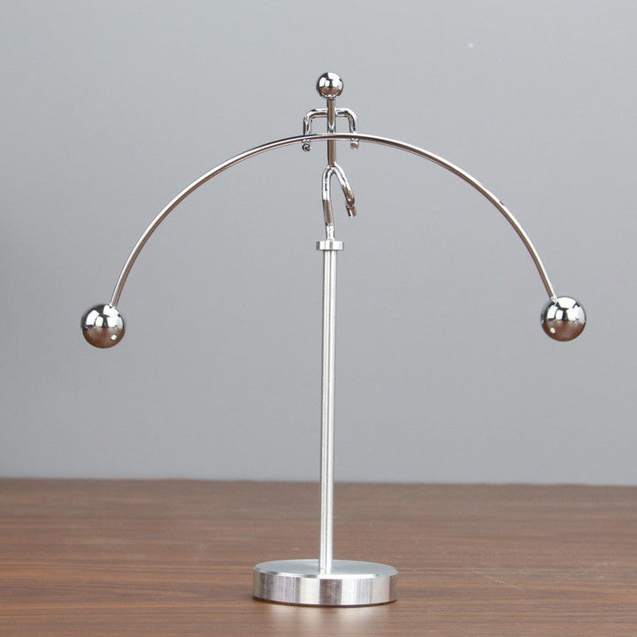 Sleek stainless steel kinetic balance pendulum, a desk toy for stress relief & office decor.