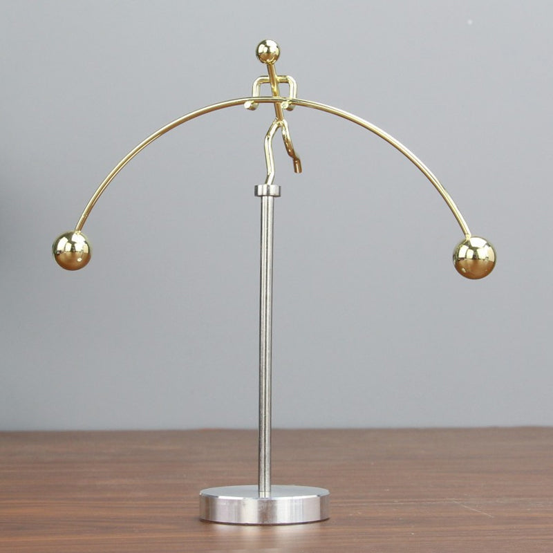Intriguing stainless steel kinetic balance pendulum, enhancing office decor with its fluid motion.
