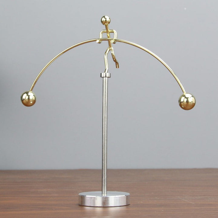 Intriguing stainless steel kinetic balance pendulum, enhancing office decor with its fluid motion.