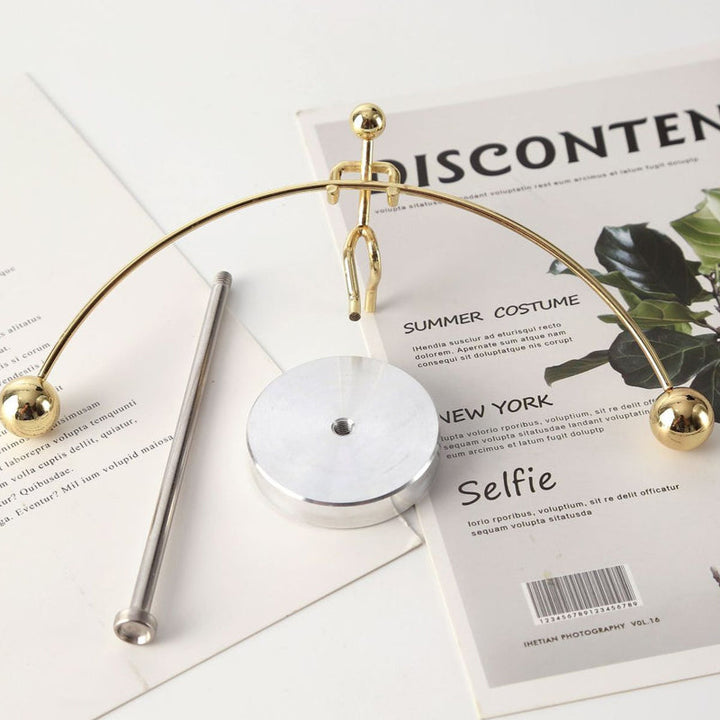 Unisex stainless steel kinetic art pendulum, a mesmerizing balance desk toy and science gift.
