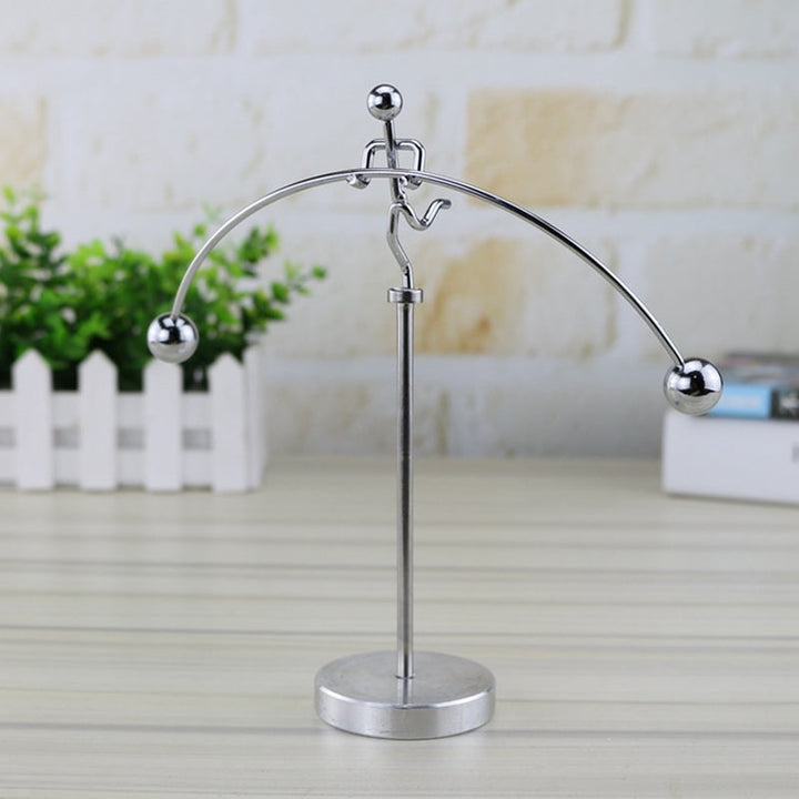 Elegant stainless steel balance pendulum, a kinetic art piece for office decor & stress relief.