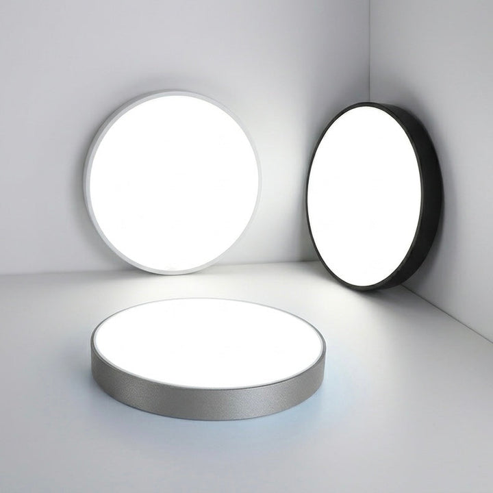 Minimalist round LED flush ceiling light, dimmable, providing efficient indoor lighting.