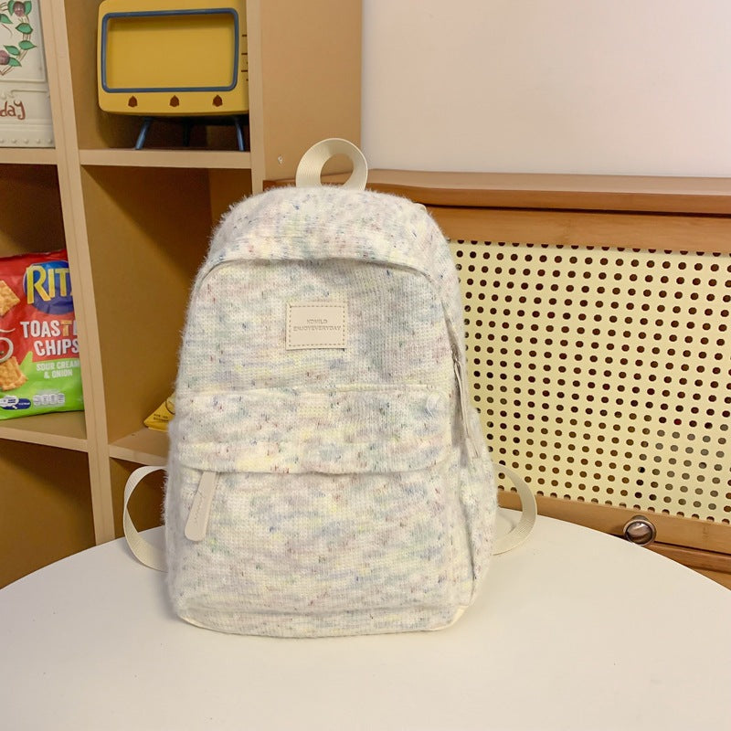 Close-up of soft, fuzzy plush fabric mini backpack, compact and stylish, perfect unisex travel accessory.
