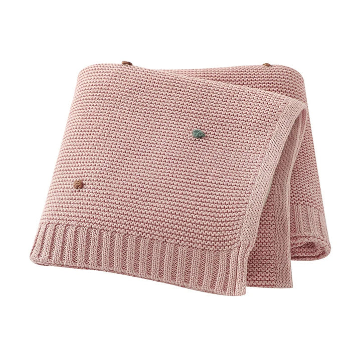 Soft unisex baby cotton knitted blanket for newborns & infants, providing comfort & warmth in the nursery.