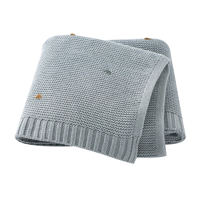 Cozy all-season unisex baby cotton knitted blanket, perfect for infant comfort & nursery decor.