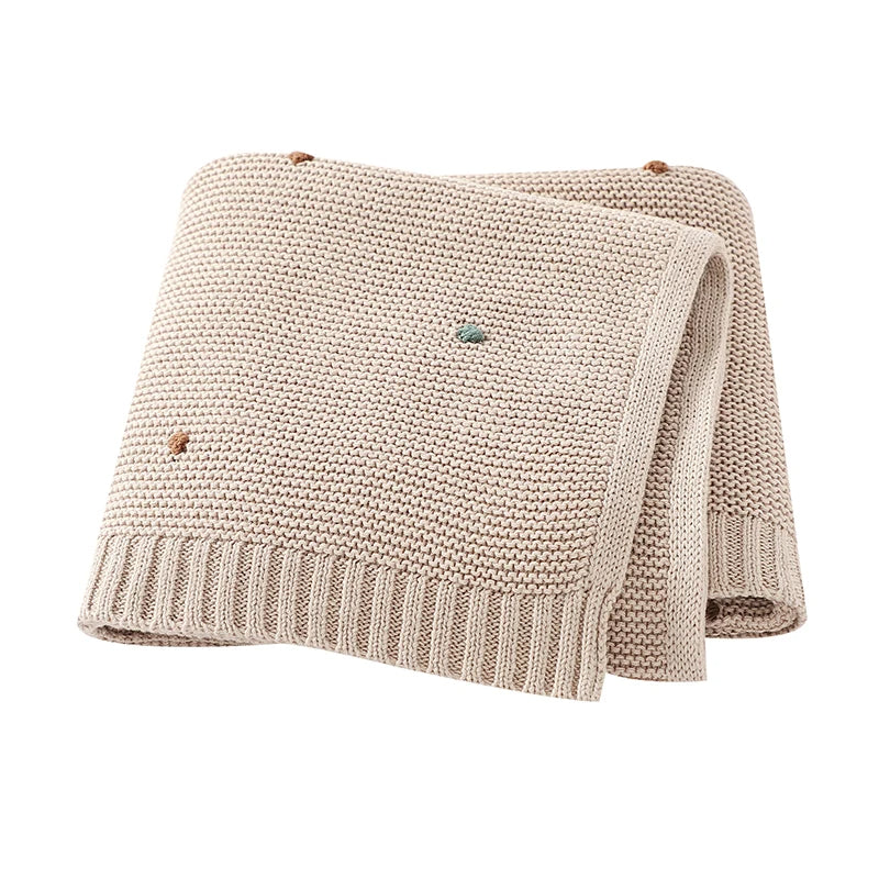 Comforting soft knitted cotton baby blanket for newborns; essential for warmth & peaceful sleep.