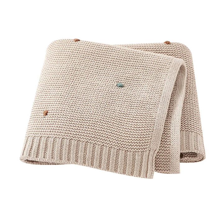 Comforting soft knitted cotton baby blanket for newborns; essential for warmth & peaceful sleep.
