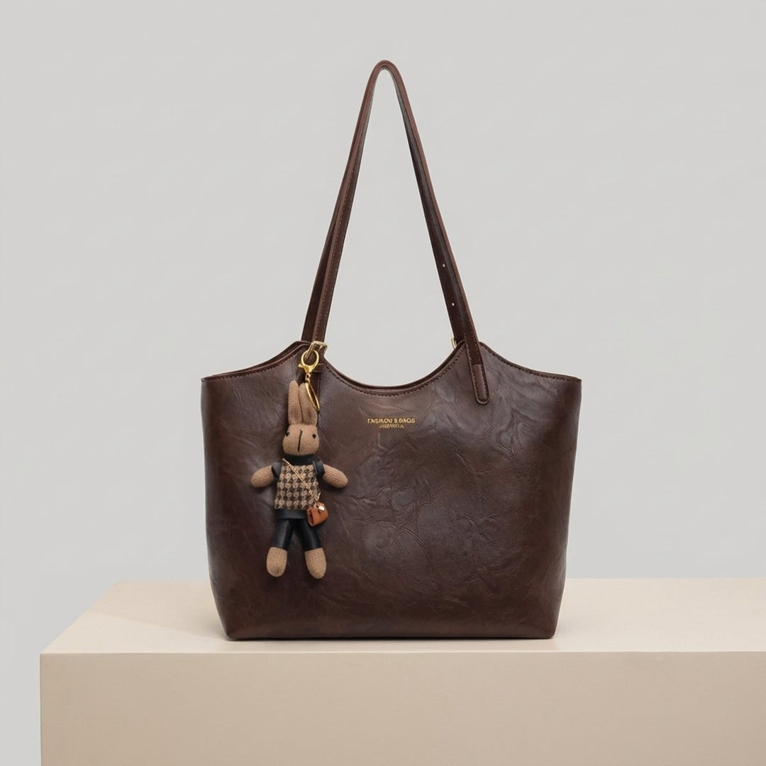 Soft vegan leather shoulder tote bag for women, featuring a cute bunny charm. Perfect everyday accessory.
