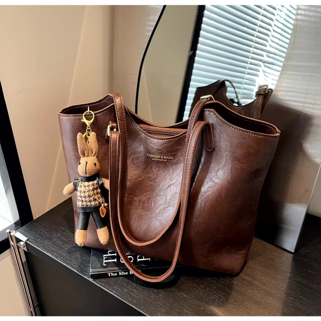 Stylish women's everyday tote bag made from soft vegan leather, complete with a charming detail.