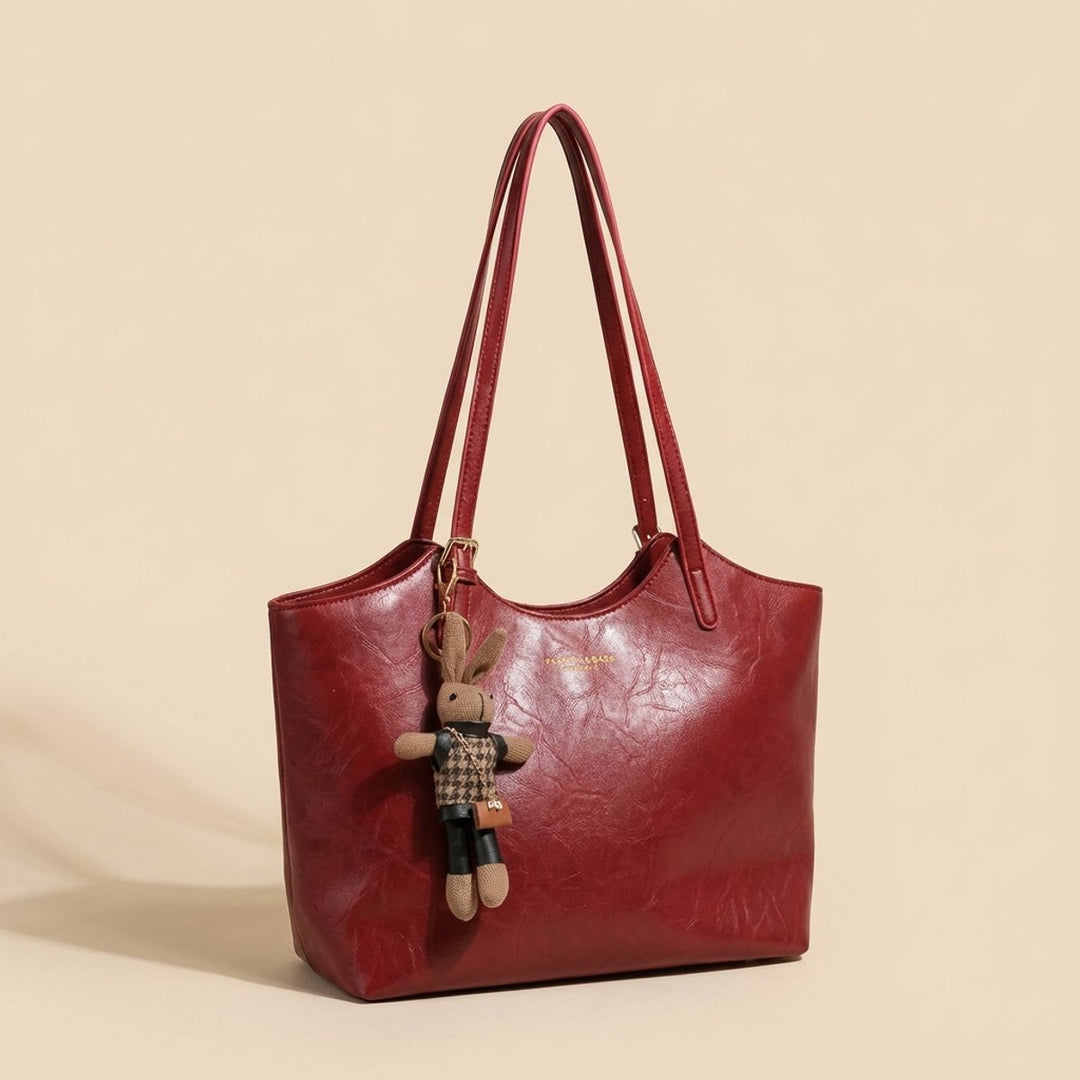 Structured faux leather shoulder bag for women, with a fashionable bunny charm. Ideal for work or daily use.