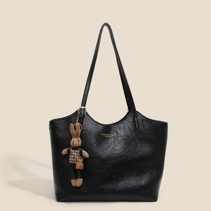 Side profile of a structured women's vegan leather shoulder bag, a versatile and stylish work tote.