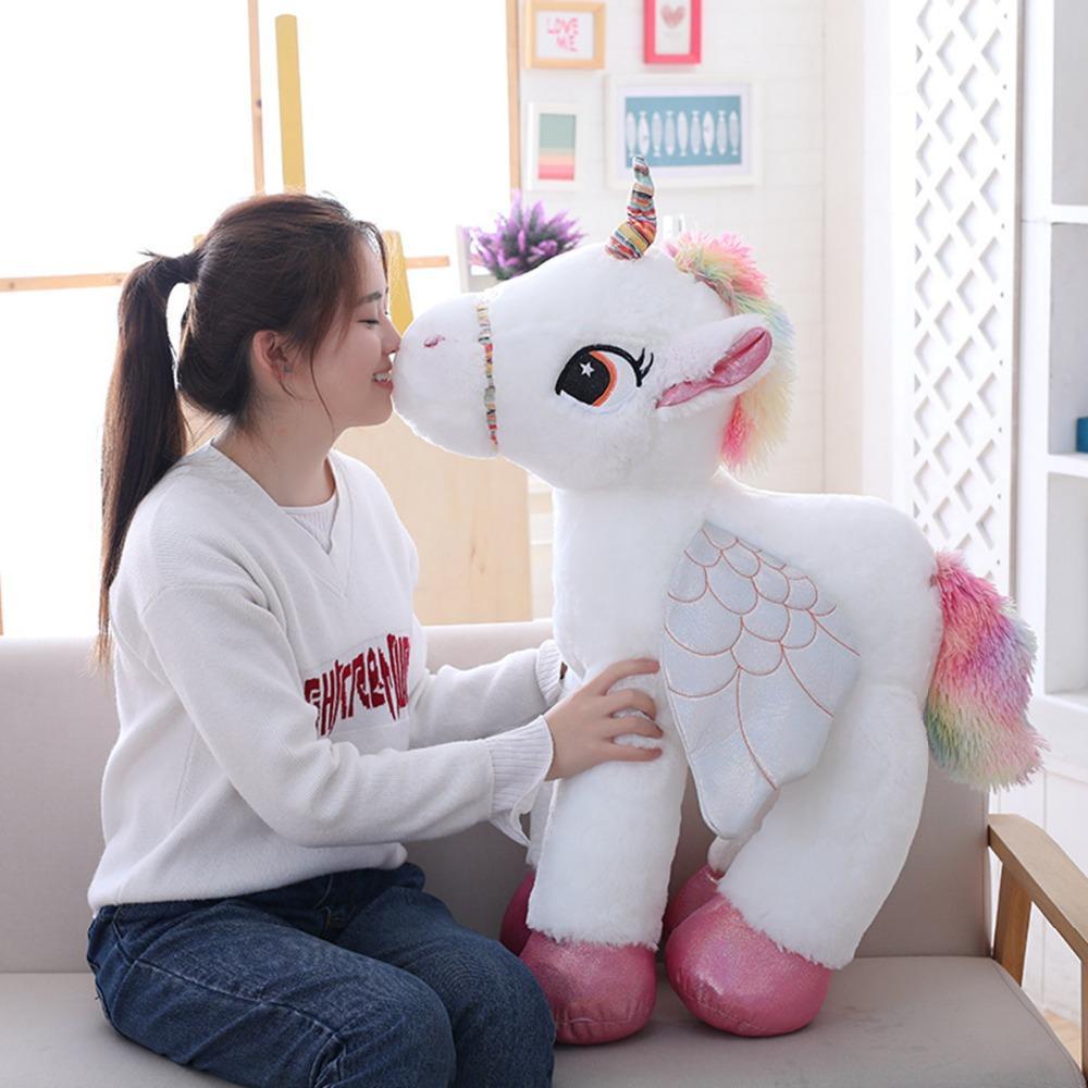 Soft white unicorn plush toy with rainbow horn and mane, perfect cuddly stuffed animal gift for kids and children's room decor.