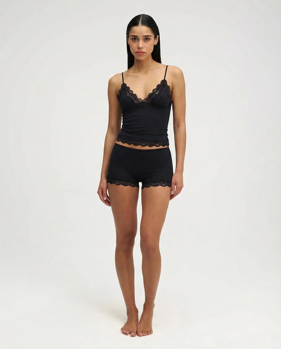 Pink women's comfortable shorts and camisole sleepwear set, featuring soft fabric and delicate lace trim.