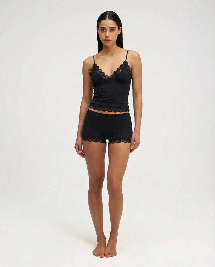 Pink women's comfortable shorts and camisole sleepwear set, featuring soft fabric and delicate lace trim.