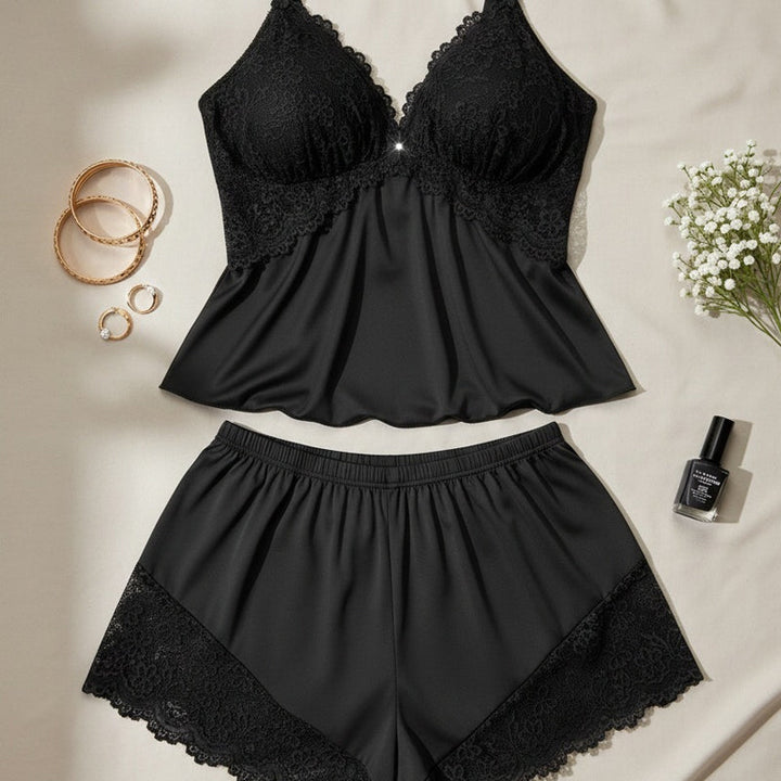 Elegant two-piece women's nightwear set, featuring a soft camisole and shorts with lace trim.