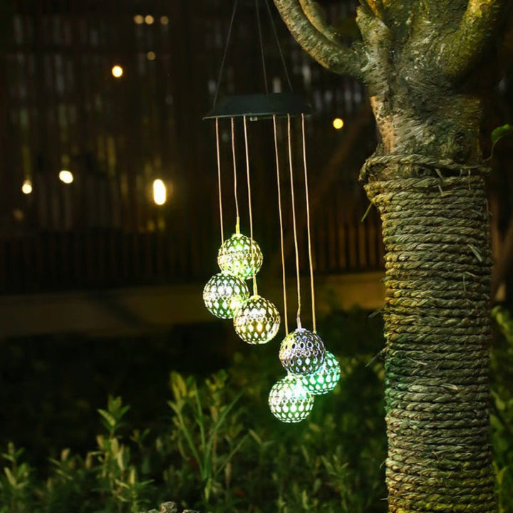 Solar color-changing LED wind chime orb, perfect for enchanting garden and patio ambiance. Eco-friendly outdoor decor.