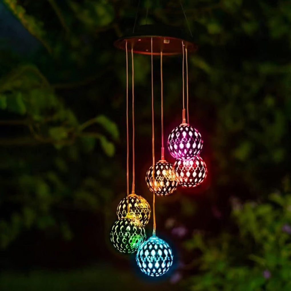 Unique solar color-changing LED wind chime orb, enhances garden and patio decor with its ambient glow.