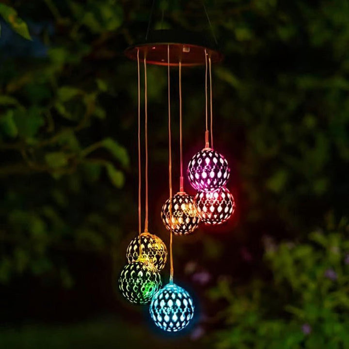 Vibrant solar color-changing LED wind chime orb. Essential outdoor decor for stunning garden and patio lighting.