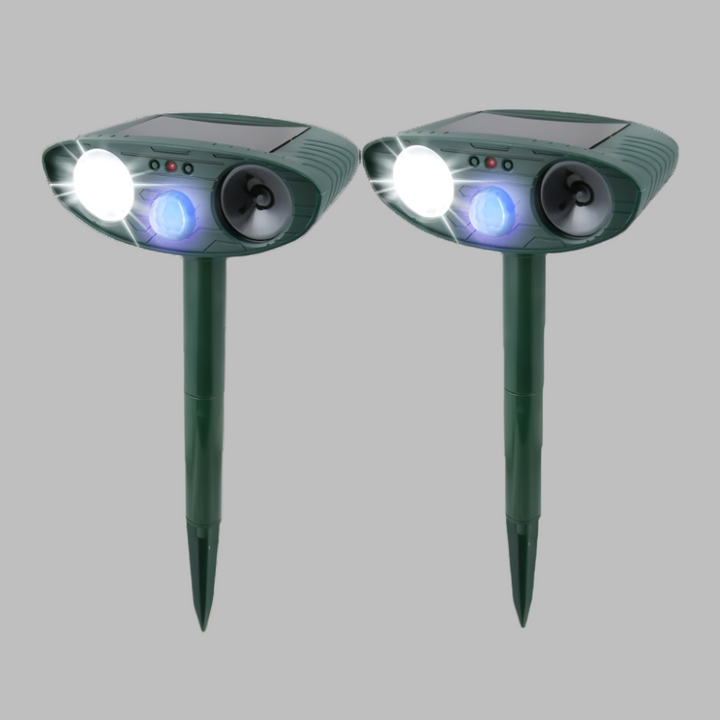 Compact outdoor solar ultrasonic rabbit repeller shown next to a hand. Easy to install humane garden protector.