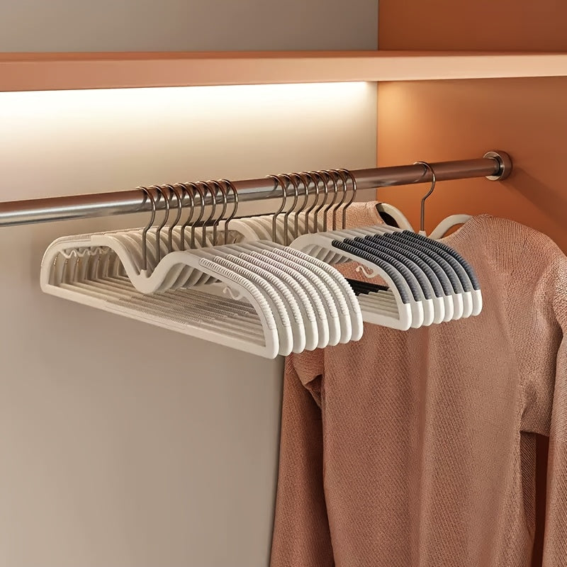 Space-saving non-slip plastic hangers with rotating hooks for organized closet wardrobes.